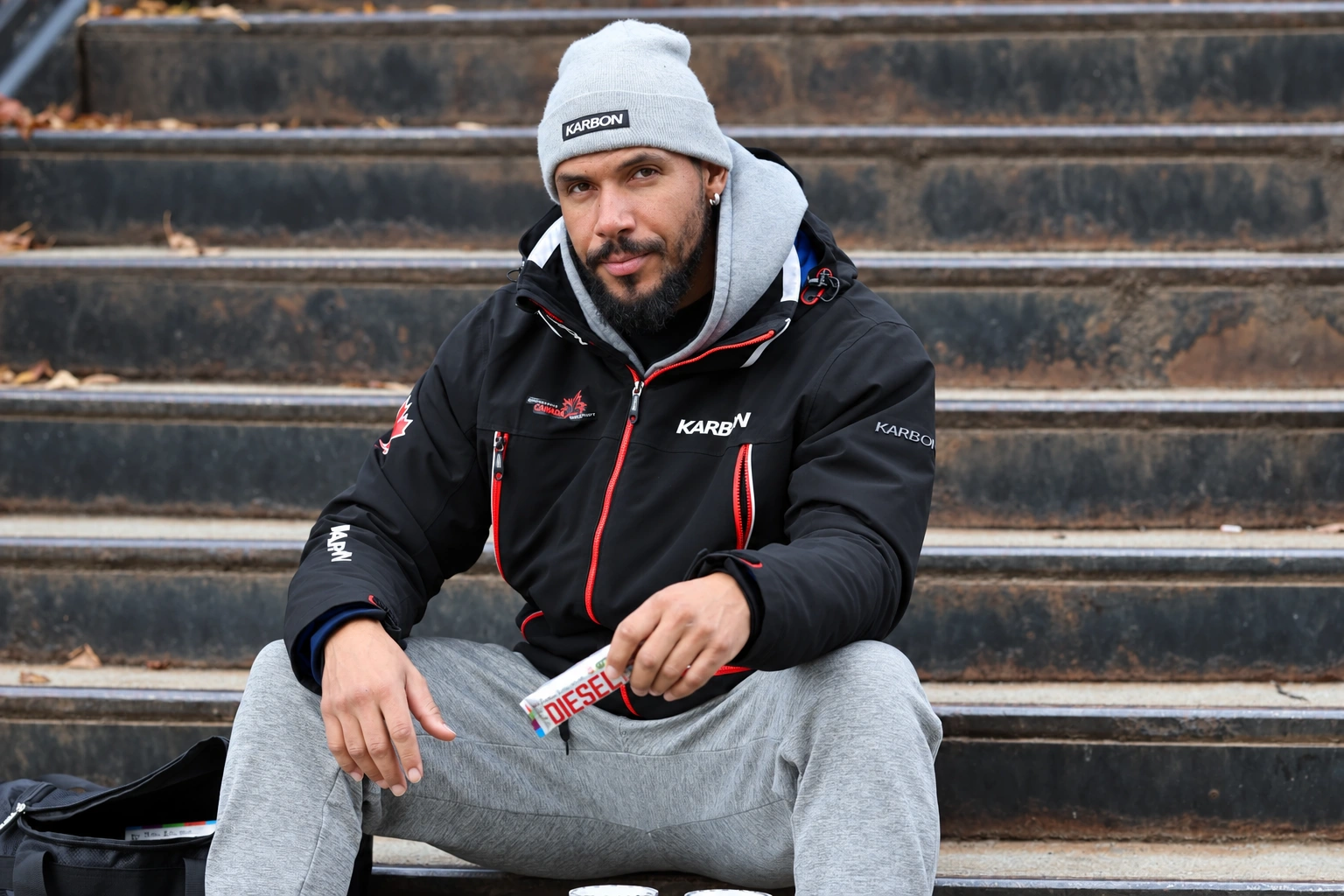 Davidson seated on stone steps in a relaxed portrait