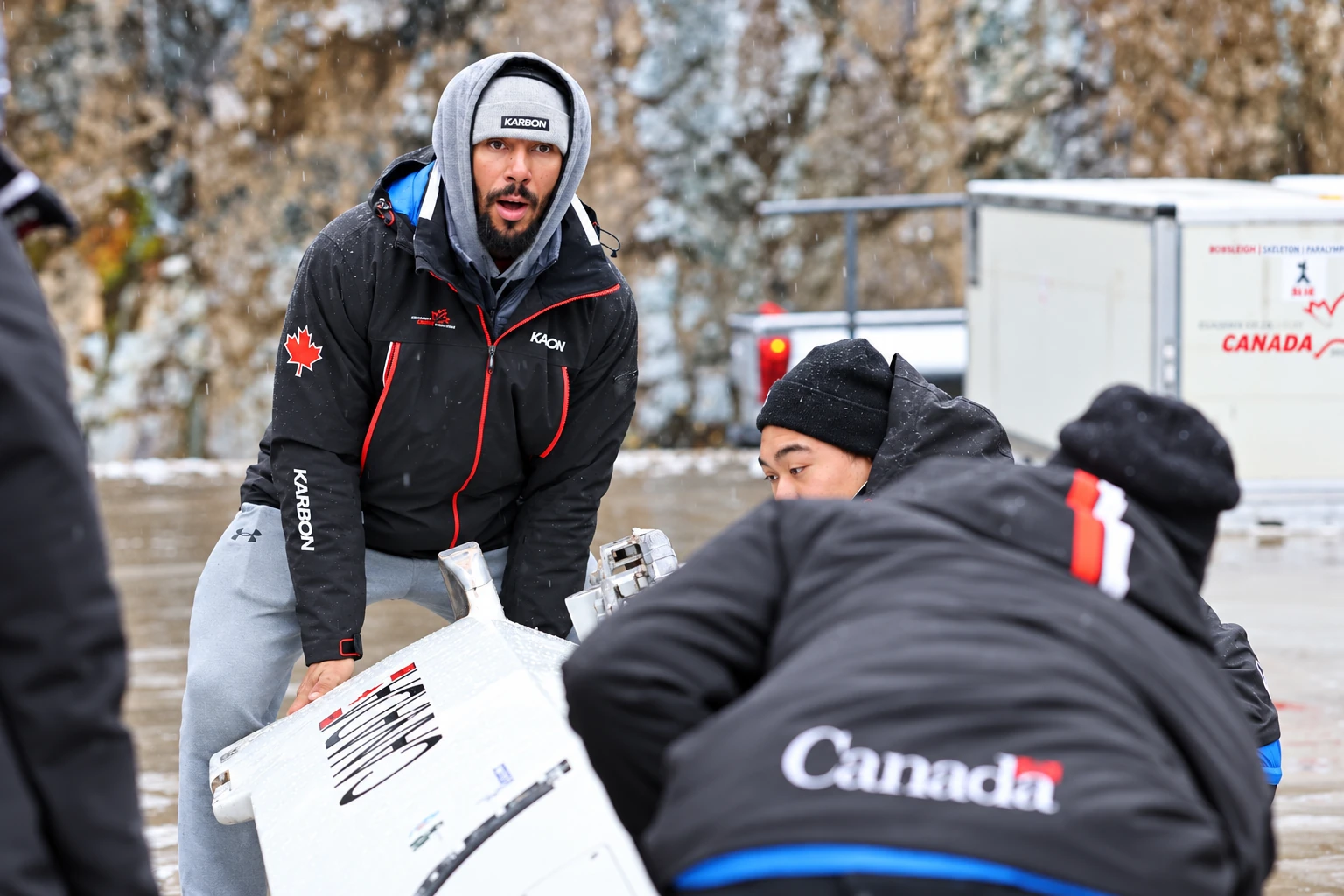 Davidson and the team handling a white bobsled in Whistler